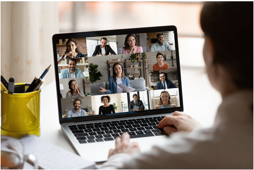 Image of a laptop open to show a screen full of faces who have joined an online session